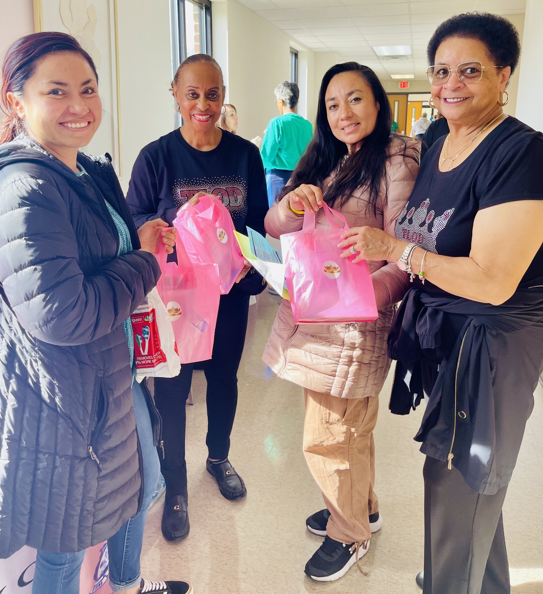 Handing out goody bags to attendees at a wellness symposium